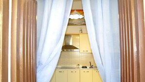 A kitchen with white cabinets, a stainless steel sink, and a hanging light fixture. - Lost in Amalfi, Your home in the heart of a peaceful village on the Amalfi Coast (Amalfi)