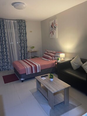 Comfort Studio, 1 Queen Bed with Sofa bed, Balcony, City View | Living area | 49-inch Smart TV with digital channels
