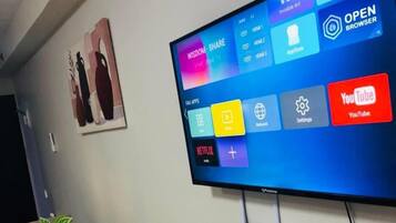 Comfort Studio, 1 Queen Bed with Sofa bed, Balcony, City View | Living area | 49-inch Smart TV with digital channels