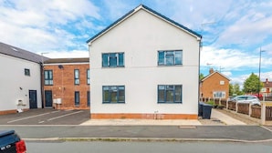 A two-story residential building with a flat roof and a brick facade. - Elegant Spacious 3BR | Shrewsbury w/ Free Parking (Shropshire)