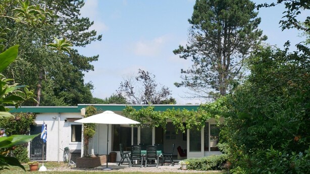 A small, single-story building with a covered patio area. - Cozy Family Home With Lovely Garden (Kamperland)