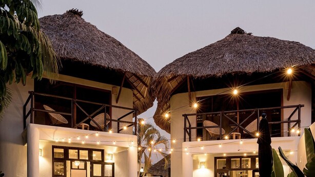 A modern villa with a pool, outdoor seating, and thatched-roof structures. - Private Pool, Chic, Step’s from beach in beautiful Puerto Escondido - WiFi, AC (Puerto Escondido)