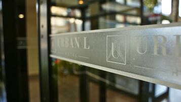 A sign with the text "URBAN L HOTEL" indicating the name of the establishment.