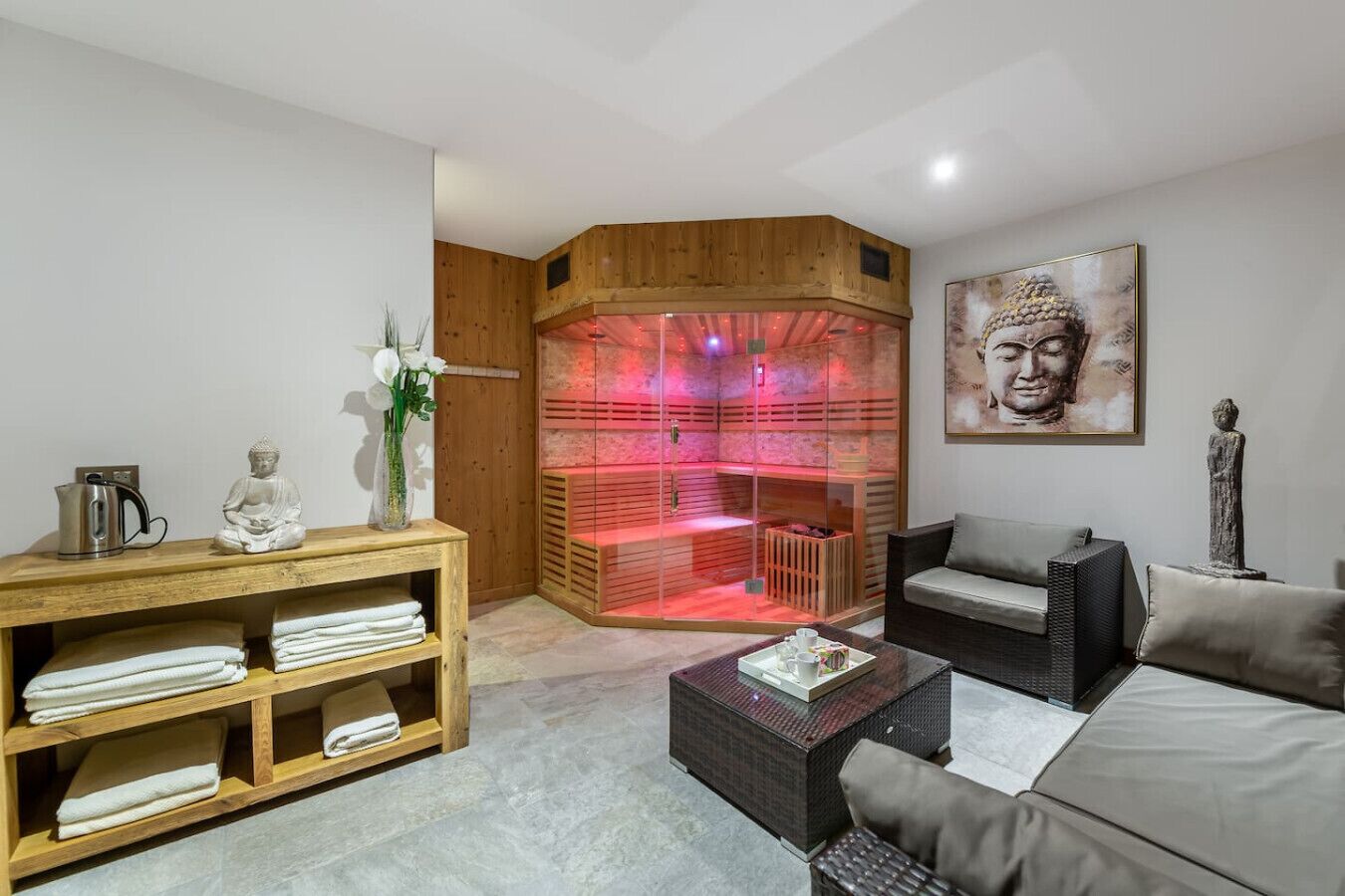 A modern living room with a wooden cabinet, a sofa, a coffee table, and a meditation area with red lighting.