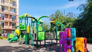 A playground with colorful play structures and a building in the background. - Studio with Balcony at Saekyung 956 (Lapu-Lapu City)