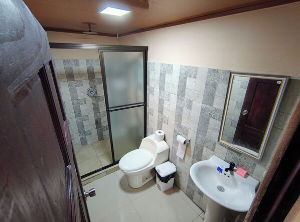 A bathroom with a toilet, sink, and shower. - Corcovado Paradise Lodge (Drake Bay)