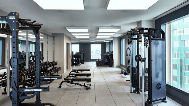 A modern gym with various exercise equipment, large windows, and a clean, spacious layout. - The Atlas Hotel Boston Cambridge (Boston)
