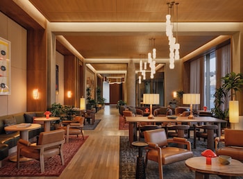 A cozy living room with a sofa, a small table, and potted plants. at The Atlas Hotel