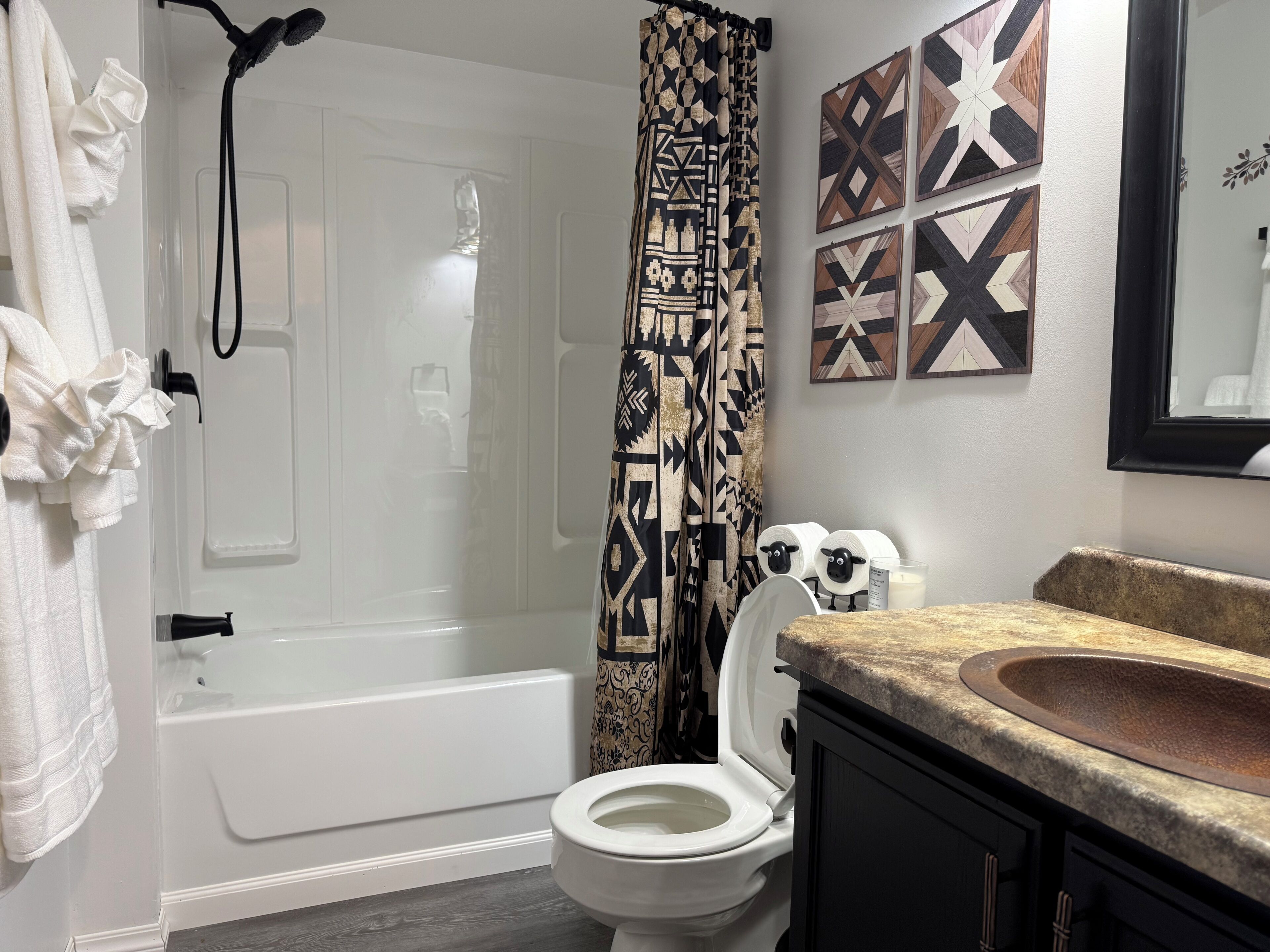 A bathroom with a bathtub, toilet, and sink.