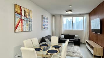 Luxury Condo, Ocean View (103) | Living area | 126-cm TV with cable channels