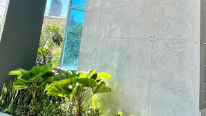 A building with a 'Signature Point' sign on a tiled wall, large windows, and some greenery in front.