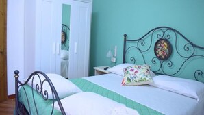 A bedroom with a bed, a wardrobe, and a nightstand. - IL GINEPRO R&B (Monghidoro)