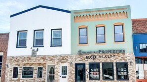 A row of buildings with a sign for 'Signature Properties exp Realty' on the front.