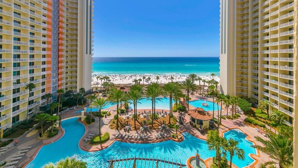 A hotel with a pool, beach view, and high-rise buildings. - Shores of Panama 816 (Panama City Beach)