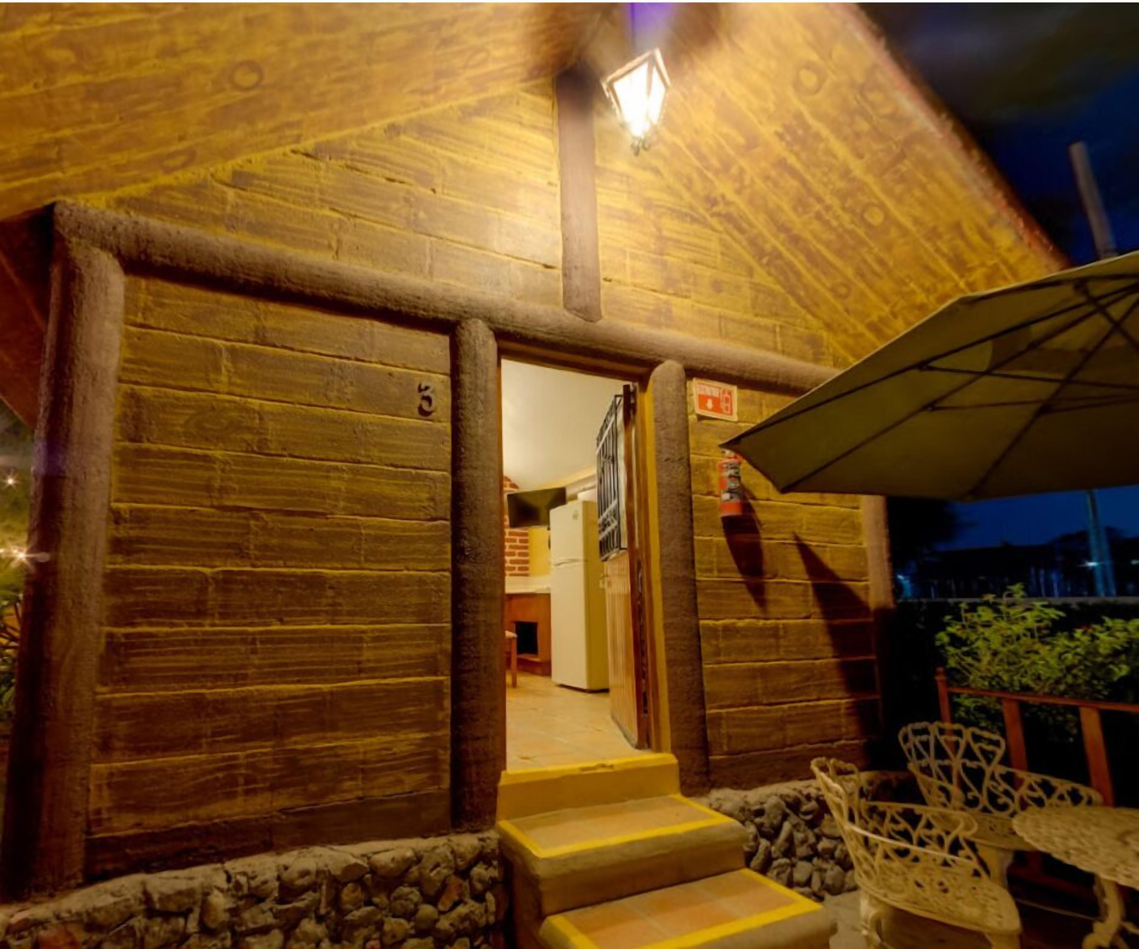 A wooden building with a staircase leading to a door marked with the number 5.