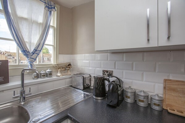 A kitchen with a stainless steel sink, a toaster, a kettle, and metal containers on the counter. - ※ Hidden Loft Apartment - Central Bath ※ (Bath)