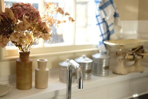 A kitchen counter with a vase of flowers, a faucet, and kitchen utensils. - ※ Hidden Loft Apartment - Central Bath ※ (Bath)