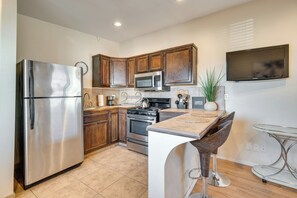 Fridge, microwave, coffee/tea maker, cookware/dishes/utensils