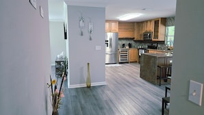 A modern kitchen with wooden cabinets, stainless steel appliances, and a central island.