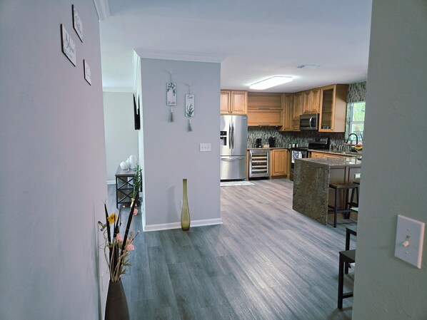 A modern kitchen with wooden cabinets, stainless steel appliances, and a central island.
