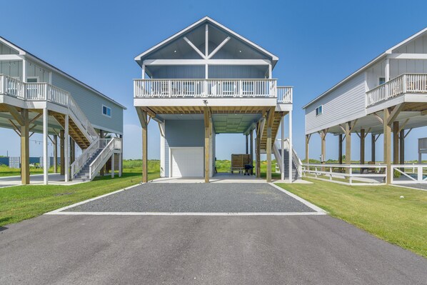 A beachfront property with two large white buildings featuring balconies and a covered walkway. - Pool Access, Deck + Patio: Bolivar Peninsula Gem (Bolivar Peninsula)