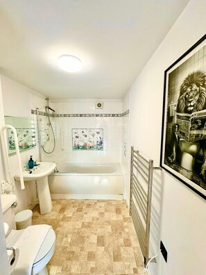 A bathroom with a bathtub, a sink, a toilet, and a shower.