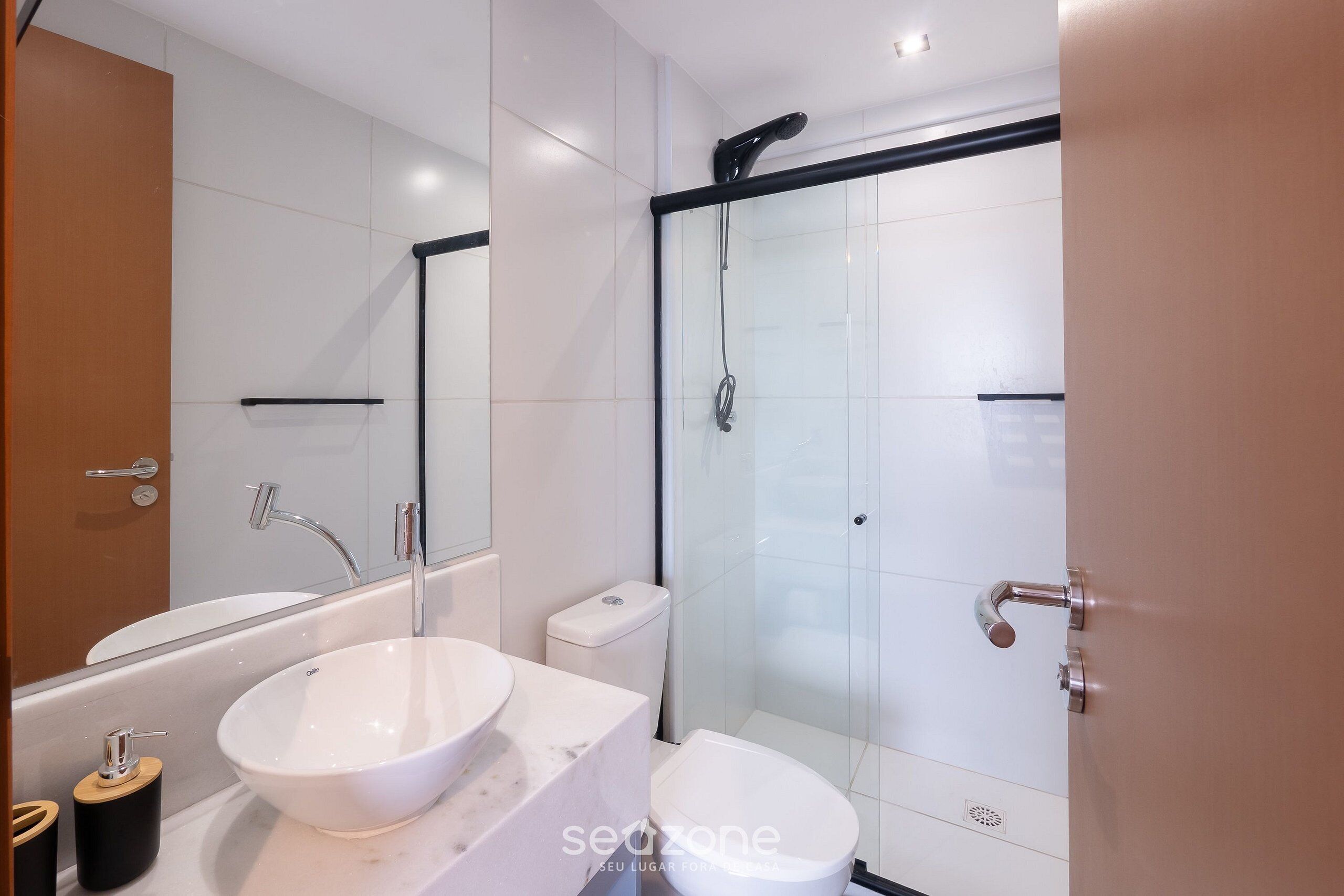 Un bagno moderno con vasca, water e cabina doccia in vetro.