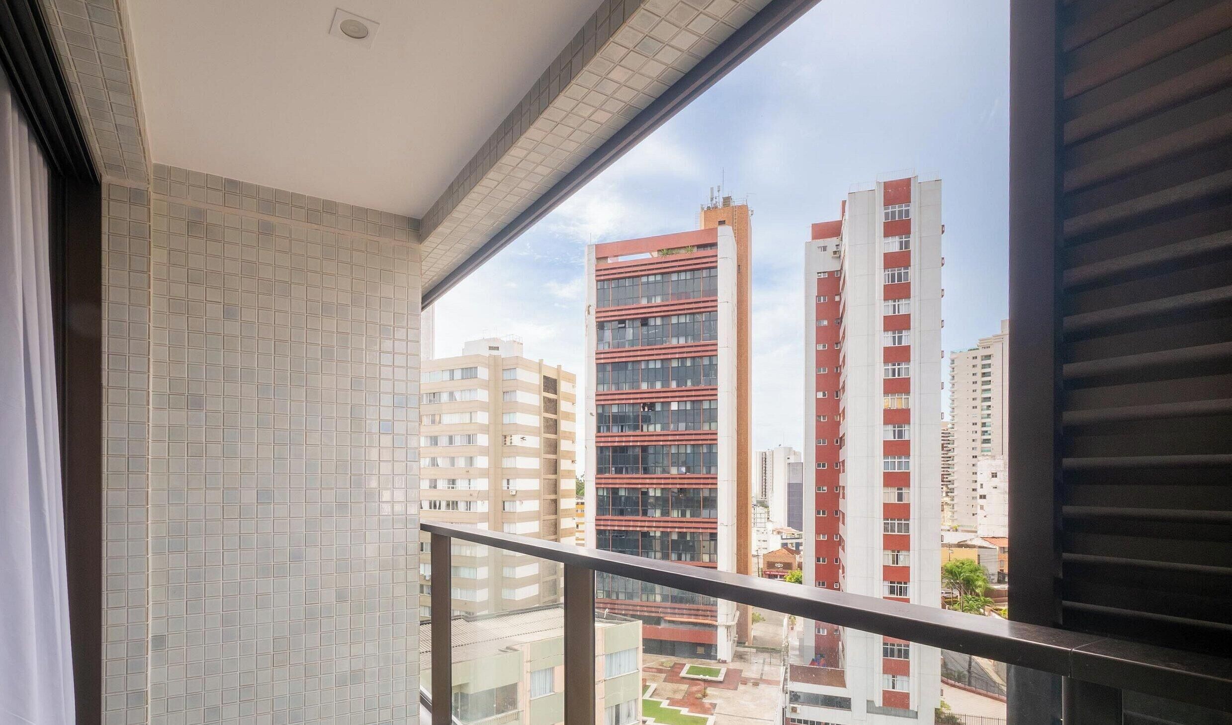 A balcony with a view of high-rise buildings.