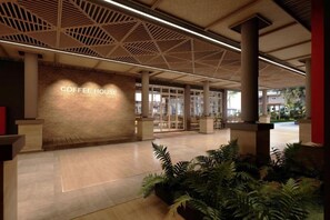 A modern coffee house with a prominent sign, a spacious entrance, and a ceiling with a geometric pattern. - Raia Beach Resort Port Dickson (Port Dickson)