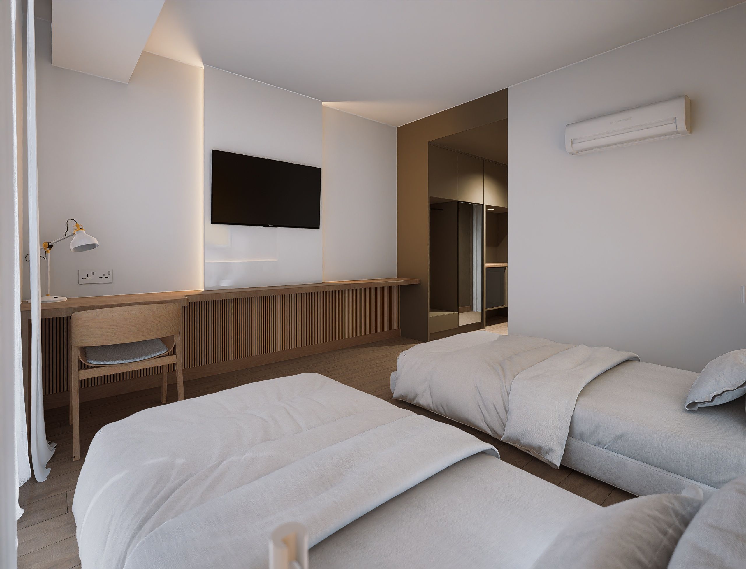 A modern hotel room with a bed, a desk, a chair, and a TV mounted on the wall.