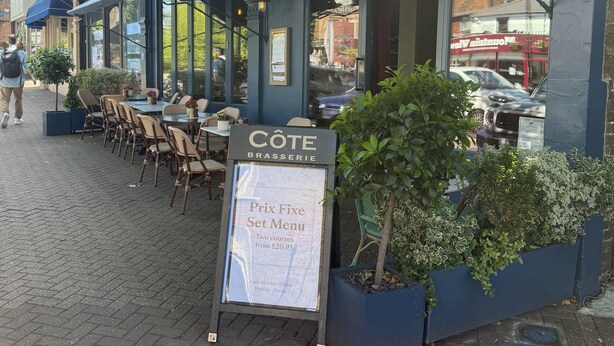 An outdoor seating area with tables and chairs, a menu board, and a sign for 'CÔTE BRASSERIE'. - Hillview Modern 3 Bed Bromley, Chislehurst House (Greater London)
