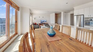 A modern kitchen with white cabinets, a stainless steel refrigerator, and a microwave. - Schnapps 3 - Mt Hotham (Hotham Heights)