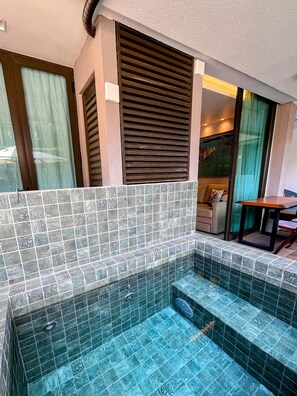 A small indoor pool with tiled walls and steps leading into it, a sofa, and a table in the background. - Sunny Hall - V.S.H. (Ipojuca)