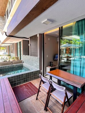 Un espace extérieur aménagé avec une piscine, une table et des chaises.