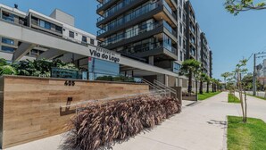 A modern building with a sign reading "Vila do Lago" and the number "405". - Cond Apartments Vila do Lago in Jurere - VLO (Florianópolis)