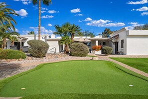 A golf course with a putting green, palm trees, and a building with a white facade. - Spacious w/Guest House - Prime Location - Private (Scottsdale)
