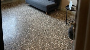 A modern room with a grey sofa, a standing lamp, and two framed pictures on the wall. - The Coccagna Hideaway Secret Whispered in the Alleys (Genova)