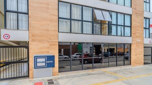 A modern building with a sign reading "HOUSE barra" and a number "366" on the facade.