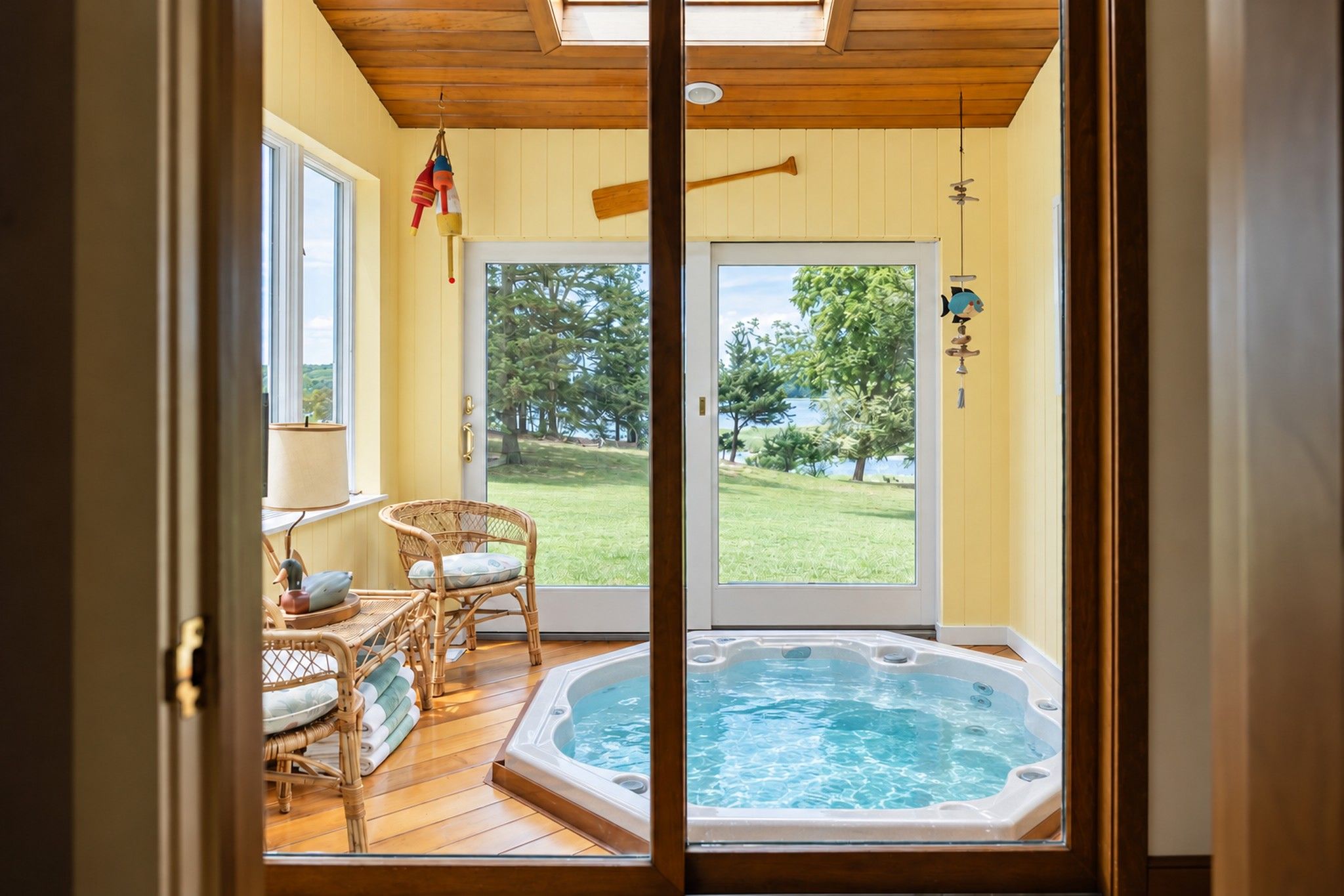Sunroom with an open private hot tub overlooking the lawn