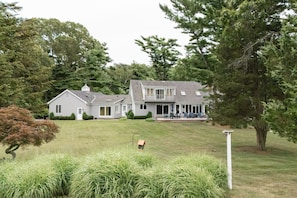 A large two-story house with a covered patio area.