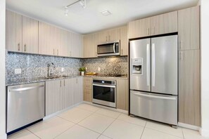 Fridge, microwave, coffee/tea maker, cookware/dishes/utensils