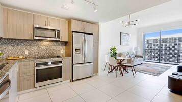 Fridge, microwave, coffee/tea maker, cookware/dishes/utensils