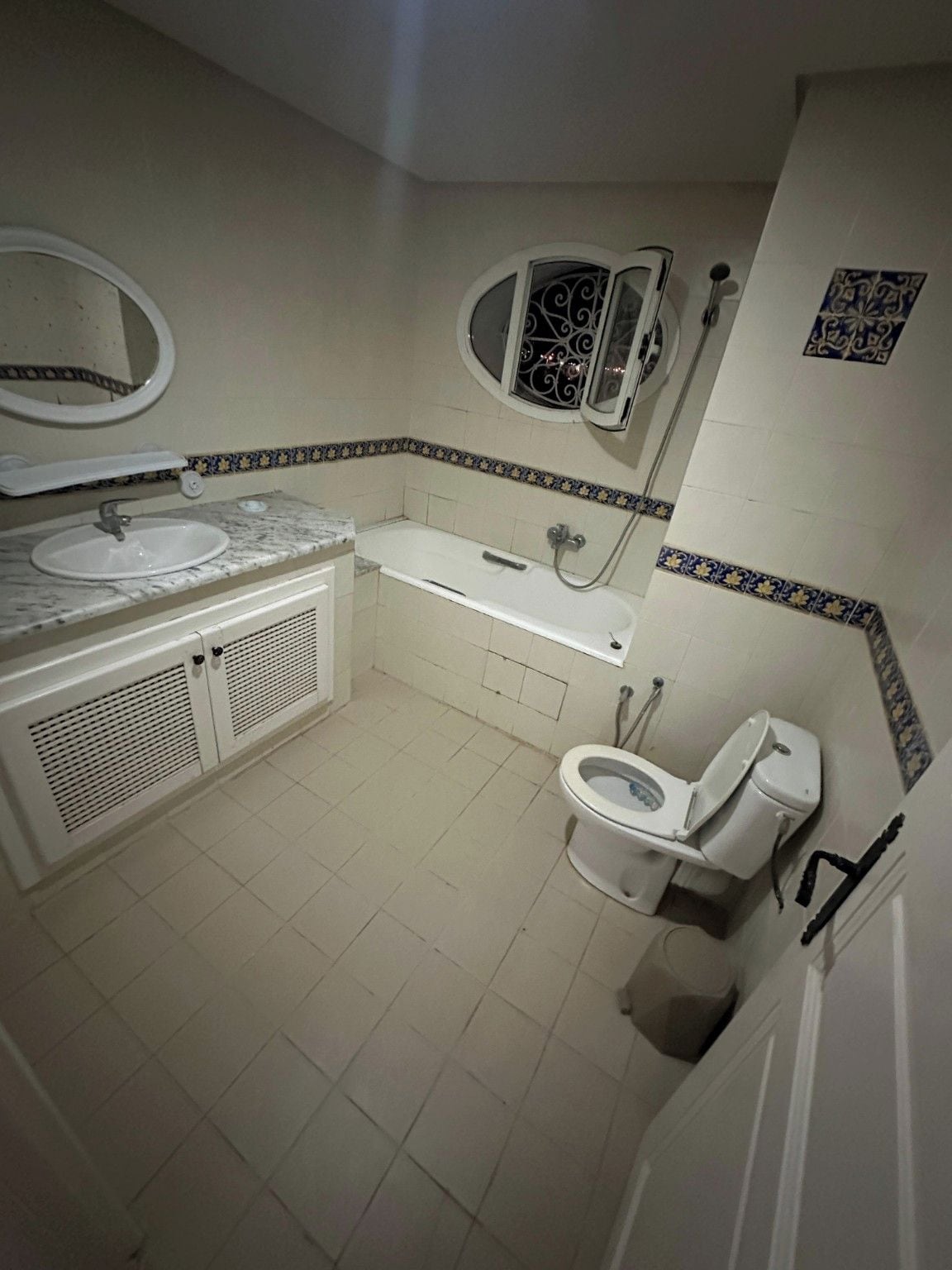 A bathroom with a sink, toilet, bathtub, and a mirror.