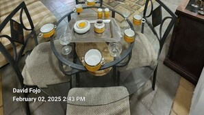 Un comedor con una mesa redonda, sillas y una barra de desayuno.