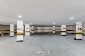 Un estacionamiento con pilares blancos marcados con números y franjas amarillas.