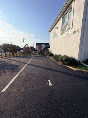 A parking lot with a building marked '1357' on the side. - SEA-clusion 1 cozy apartment across the street from the beach! (Norfolk)