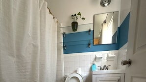 A bathroom with a toilet, sink, and bathtub.