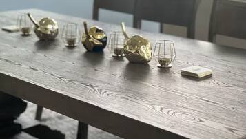 A wooden table with several glassware items and a gold-colored object.