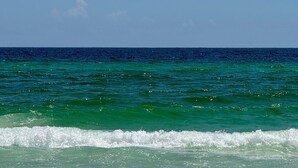 A beach with clear turquoise water and white sand.
