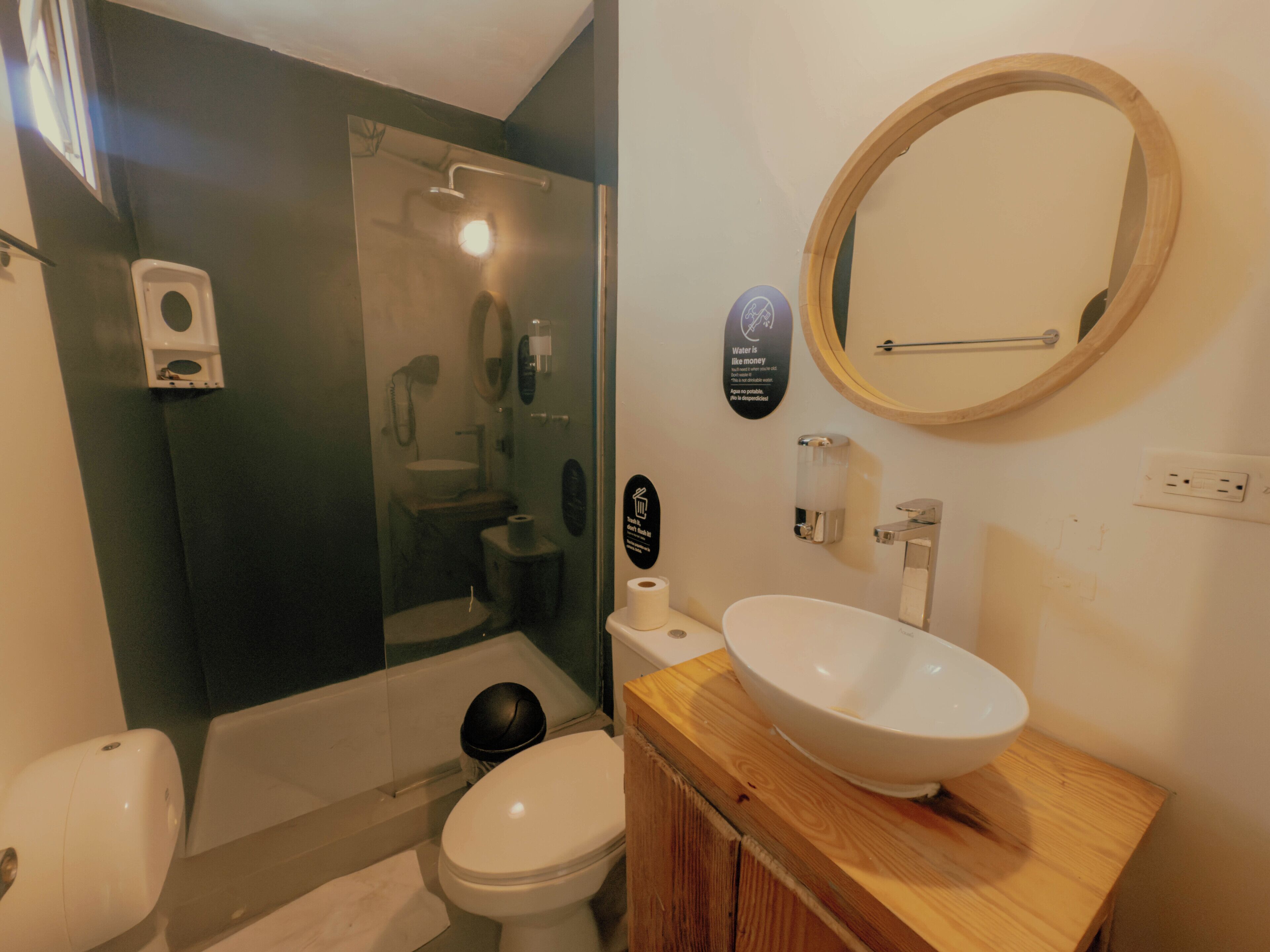 A bathroom with a toilet, sink, and shower.